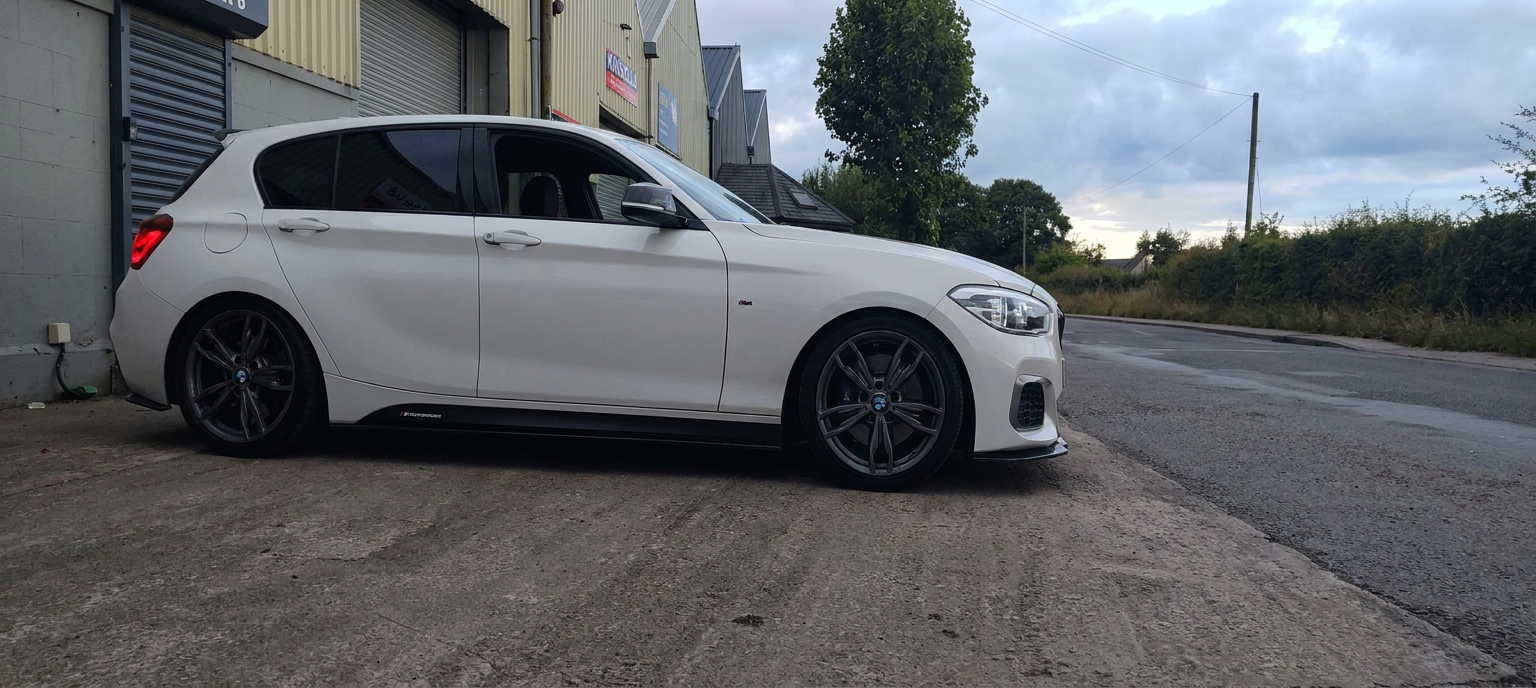 White BMW M140i with dark tinted rear windows parked outside the Gorey tinting workshop