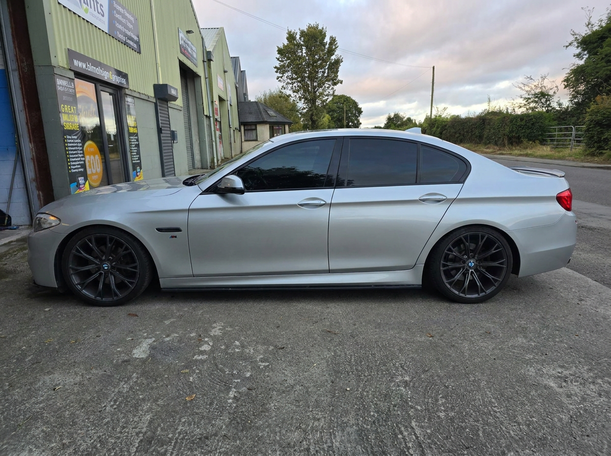 Silver BMW saloon with tinted side windows