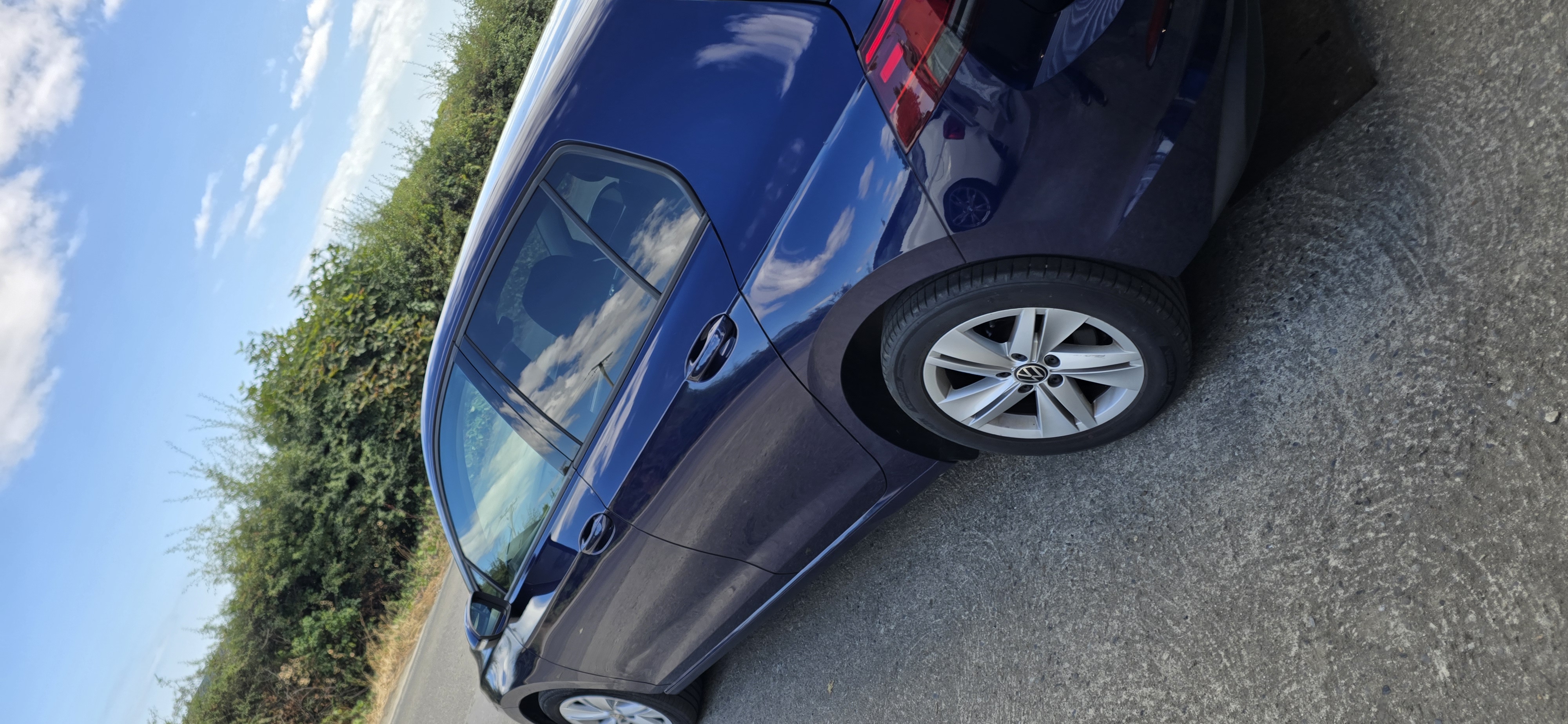 Side profile of a blue Volkswagen Golf with dark tinted rear side glass in Co. Wexford